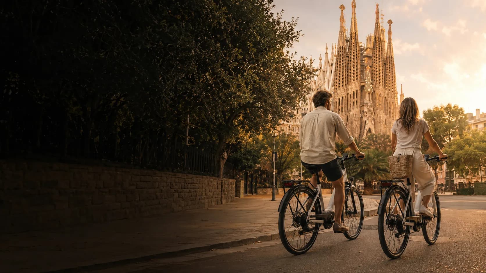 Two cyclists pause in front of the Sagrada Família on a Ride BCN private e-bike tour.